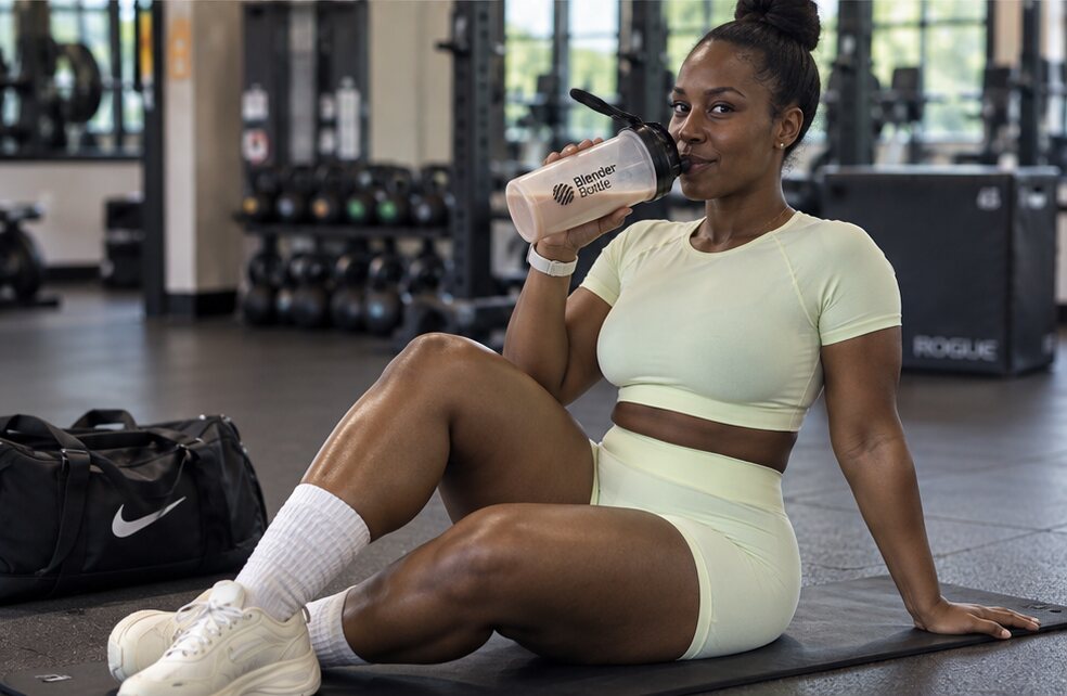 Andrea enjoying a protein shake after a gym workout